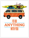 orange and cream volkswagen camper van with sea kayak, snowboard, skis and a bike on the roof.